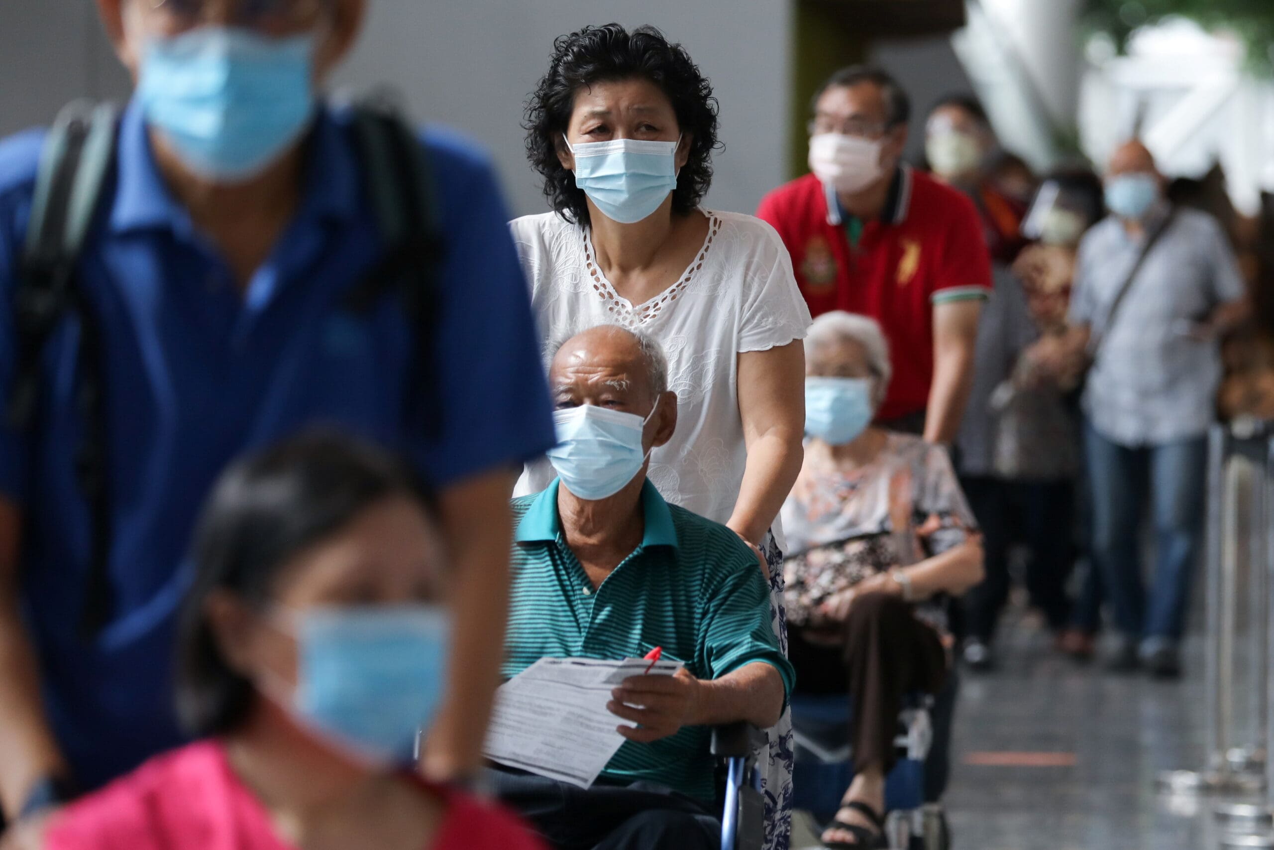 FILE PHOTO: People wait to receive coronavirus disease (COVID-19) vaccines at a vaccination centre in Kuala Lumpur, Malaysia May 31, 2021. REUTERS/Lim Huey Teng